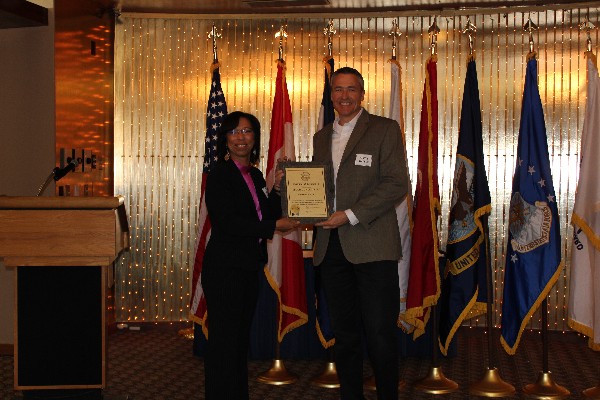 In April, Col. Joyce Jenkins-Harden, USAF (Ret.) (l), chapter vice president, presents Kevin Mackey, vice president of federal sales for Epoch Concepts, with an appreciation plaque for his company's AFCEA corporate sponsorship.